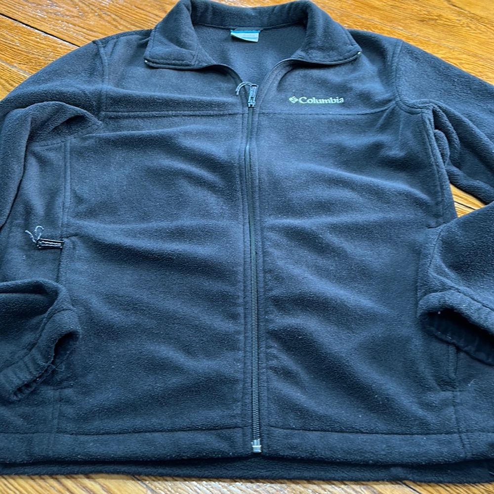 Columbia black fleece zip front jacket. Size Medium.  Zip pockets, toggle.